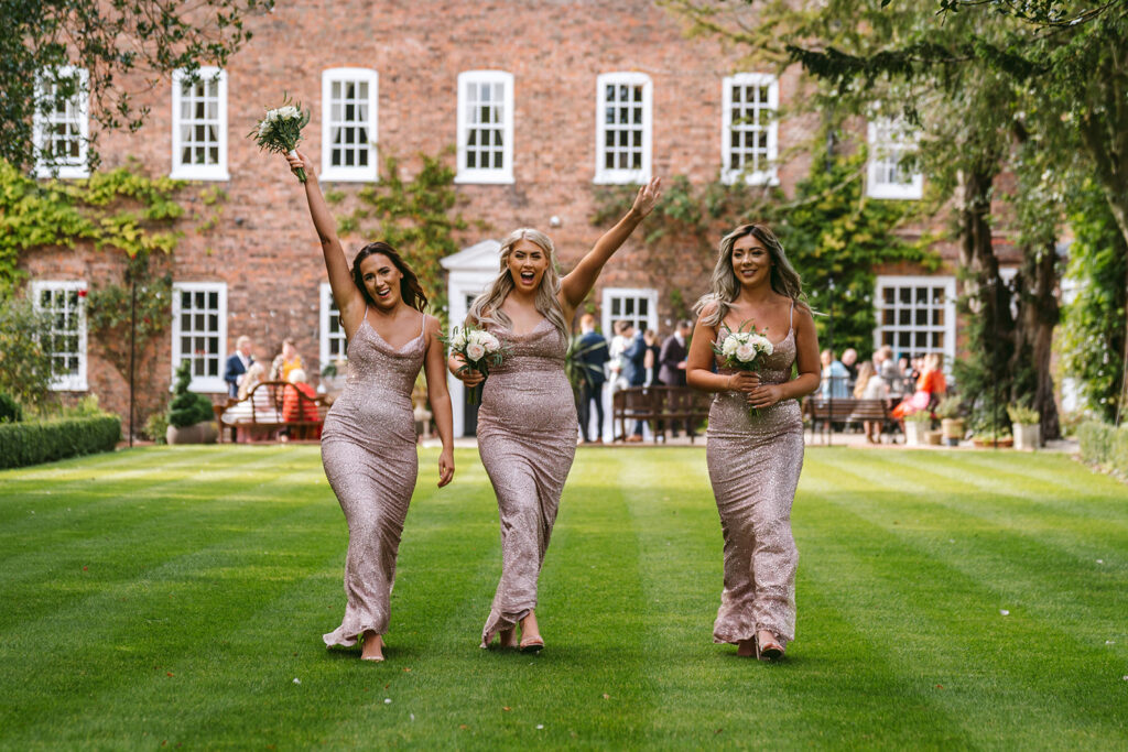 Bridal party in beautiful lawned wedding venue setting